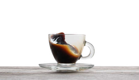 Cup of  splashing coffee isolated on whiteの写真素材