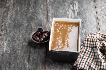 Sticky toffee pudding butter sponge with dates on wooden table