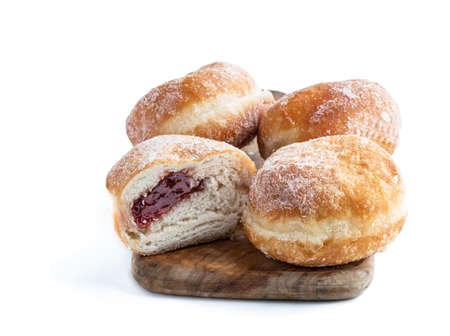 Tasty  freshly baked doughnut with jam filling isolated on white backgroundの写真素材