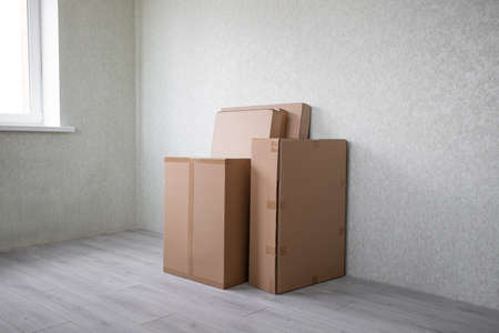 Brand new selection of furniture in cardboard boxes just arrived in new homeの写真素材