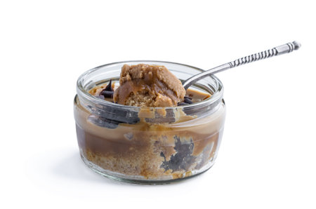 Mini caramel cheesecake in a glass pot isolated on white