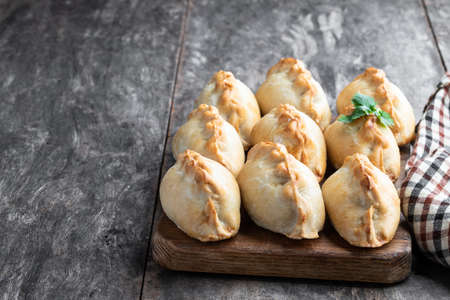 Vegan  shortcrust pastry with potato and carrot with onion and swede on wooden tableの写真素材