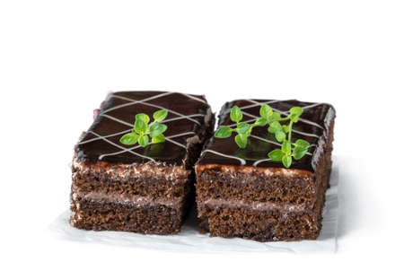 Slices  of chocolate cake with cream isolated on whiteの写真素材