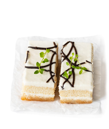 White  vanilla cake slices with cream on wooden table