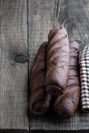 Mini  rye loafs on rustic wooden tableの写真素材