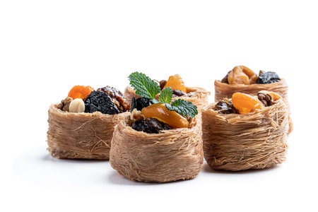 Traditional arabic and turkish sweets pastry dessert kadaif with nuts and dried sweetened fruits...