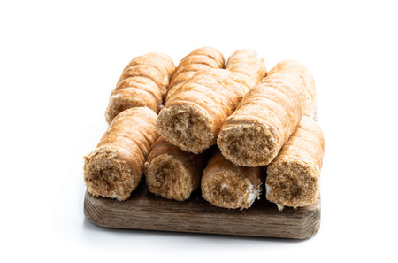 Elegant french cream horn pastries on wooden board isolated on whiteの写真素材