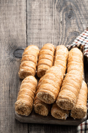 Elegant french cream horn pastries on wooden board