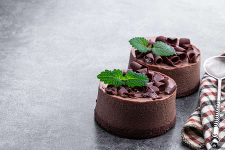 Mini Chocolate Cheesecakes with chocolate chips on top on gray backgroundの写真素材