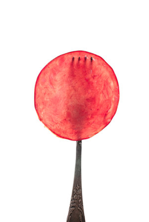 Dried meat beef jerky slice on fork isolated on whiteの写真素材