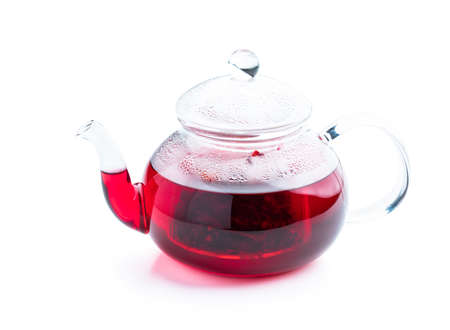 Hot fruit tea in glass teapot isolated on whiteの写真素材