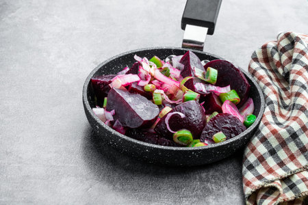 Baked beetroot and leek in frying pan on gray backgroundの写真素材