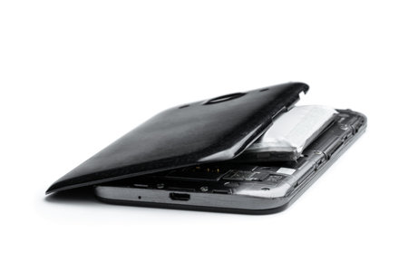Smartphone destroyed by exploded lithium battery isolated on white