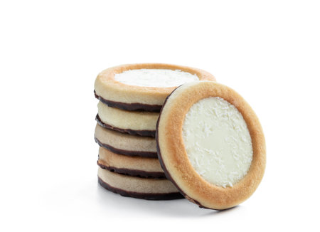 Stack of cream and coconut filling biscuits isolated on whiteの写真素材