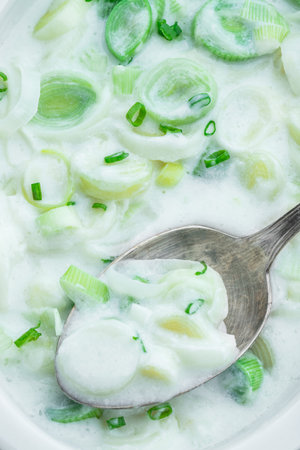 Buttered creamy leek background with spoonの写真素材