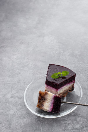 No sugar layered cheese cake made from stevia and berry jelly on gray backgroundの写真素材