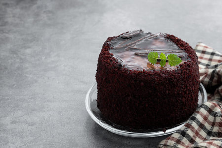 Chocolate mini cake with chocolate ganash on gray background