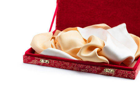 Gift box with colorful silk scarf inside isolated on a white backgroundの写真素材