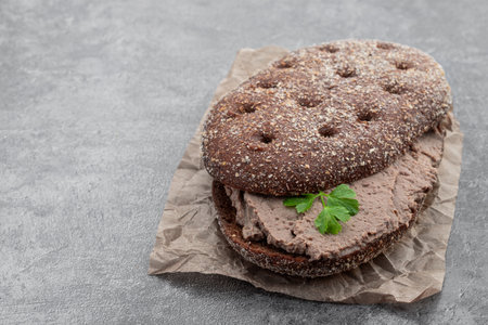 Liver meat pate spread on rye bread on gray backgroundの写真素材