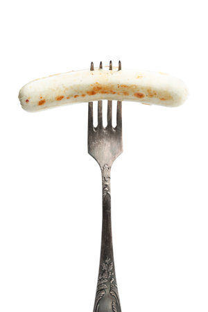 Grilled white thin chicken sausages on fork isolated on whiteの写真素材