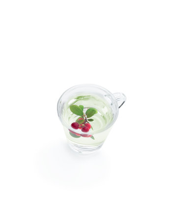 Tasty lingonberry tea isolated on whiteの写真素材