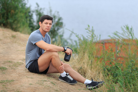 The young athlete is tired and sits. Travel sport lifestyle concept.の写真素材