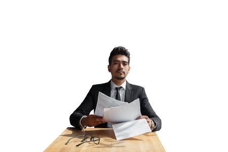 Handsome young businessman with documents in hand isolated over white backgroundの写真素材