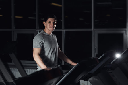 man smiling at the gym doing exercise on the treadmill