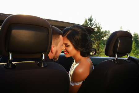 bride and groom. Young wedding couple enjoying romantic moments outside on a summer meadow. Happy bride and groom on their wedding. Stylish beautiful happy bride and groom, wedding celebrationsの写真素材