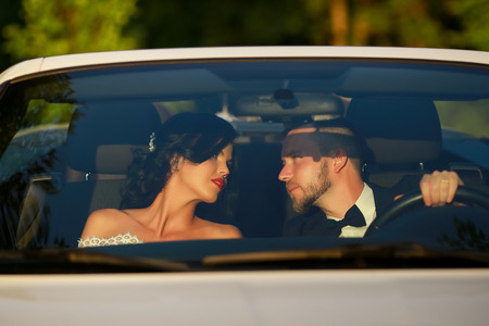 bride and groom. Young wedding couple enjoying romantic moments outside on a summer meadow. Happy bride and groom on their wedding. Stylish beautiful happy bride and groom, wedding celebrationsの写真素材
