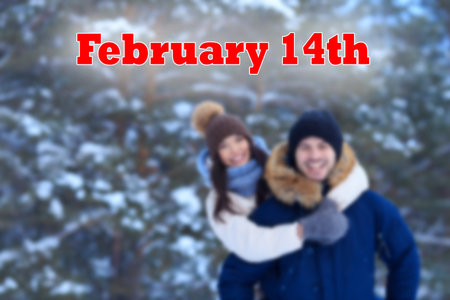 14th of Fabruary romantic celebration in winter pine forest. Young couple on Valentines Day