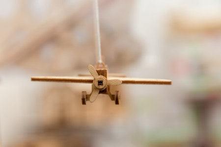 miniature wooden scale airplane gears in the air