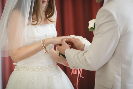 bridegroom puts the ring on the bride. Wedding ceremony.の写真素材