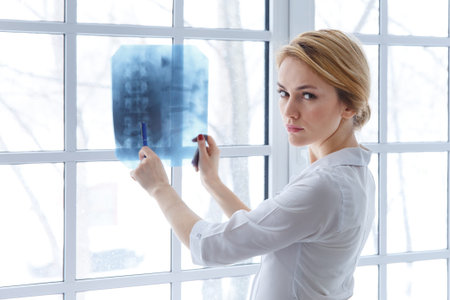 young medical doctor woman pointing on x-ray.