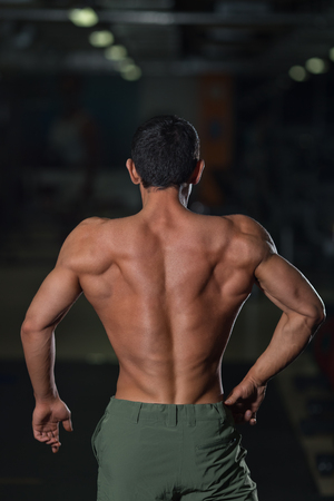 Strong athlete with muscular body, back view. Fit lifestyle. Strength trainings and workouts conceptの写真素材