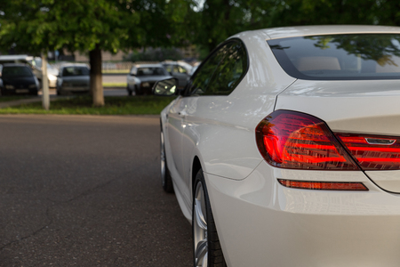 Back side of white luxury beautiful car outdoor.の写真素材