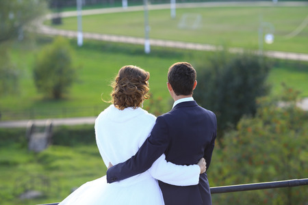 groom in love and the bride embrace on walk in the park in the summer.の写真素材