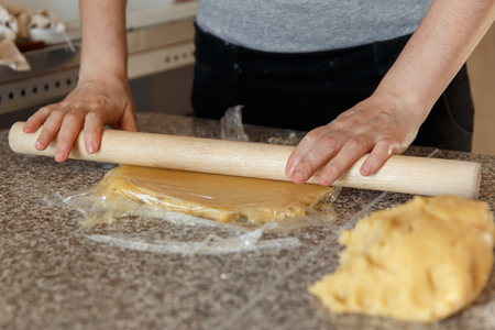 Baker kneading dough in flour on table.の写真素材