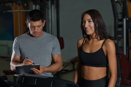 Sport couple on workout in fitness club. Active lifestyle, man and woman in gymの写真素材