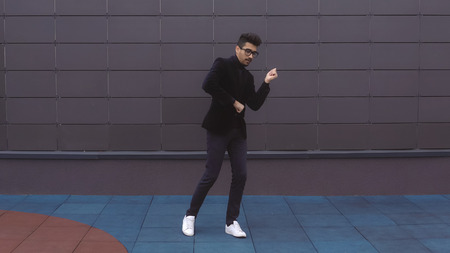 Happy dancer man wearing suit.の写真素材