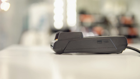 payment terminal on the table on blurred shop background.の写真素材