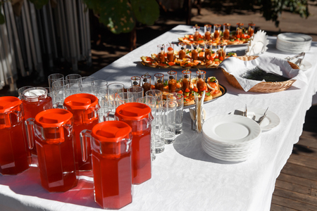 Beautifully decorated catering banquet table with different food snacks and drinks.の写真素材