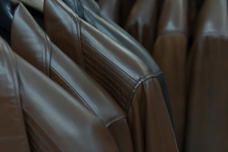 Close up of brown leather jackets on the rack. Luxury wear in fashion store. Sale, consumerism and shopping conceptの写真素材