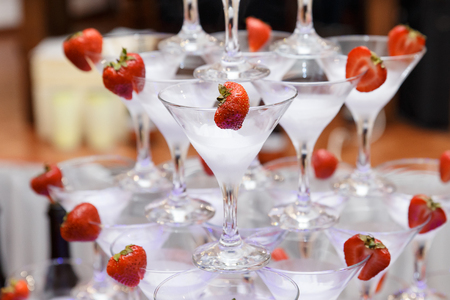 pyramid from glasses of champagne with strawberry on wedding party, close upの写真素材