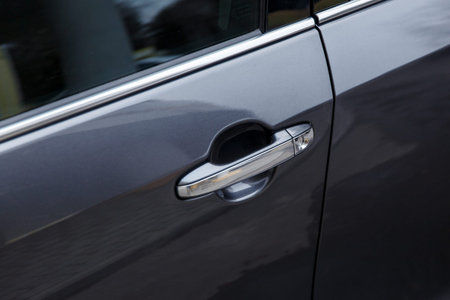 Door of a black car. Glossy coating