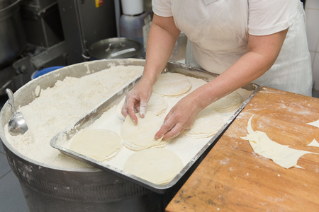 Baker works with the dough on production.の写真素材