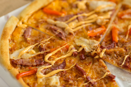 Fresh hot pizza with pieces of red pepper and cervelat. Junk food.の写真素材