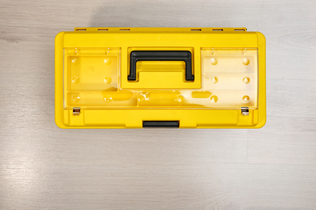 From above of closed yellow plastic box with tools and accessories.の写真素材