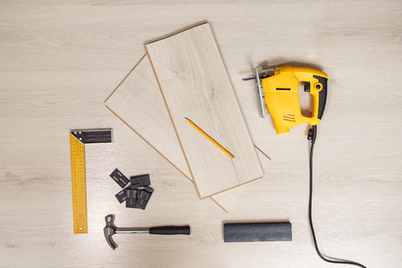 Top view of arranged wood cutting instrument with planks on wooden backgroundの写真素材
