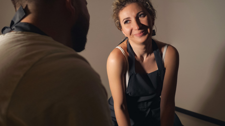 couple looking at each other in clay studio, close upの写真素材